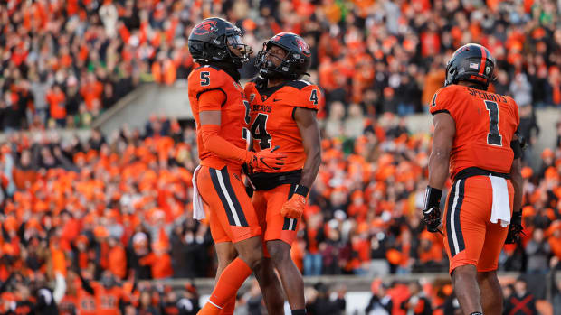 Nov 26, 2022; Corvallis, Oregon, USA; Oregon State Beavers running back Deshaun Fenwick (5) reacts with teammate Travis Throckmorton (4) during the second half against the Oregon Ducks at Reser Stadium.